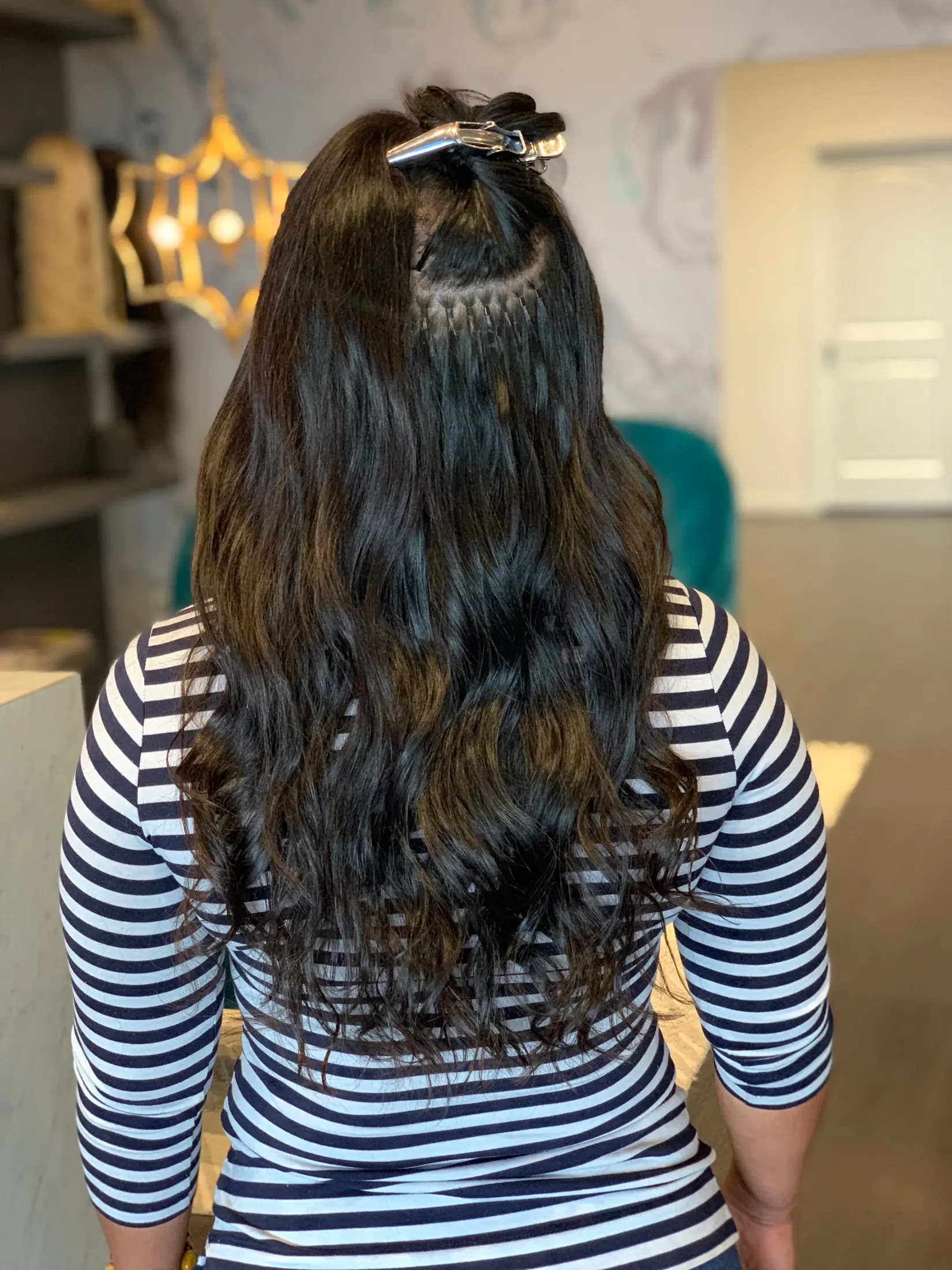 Close view of a microbead extension row installed flat against the scalp